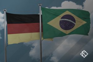 A imagem mostra uma bandeira brasileira e uma alemã. A imagem ilustra a publicação 