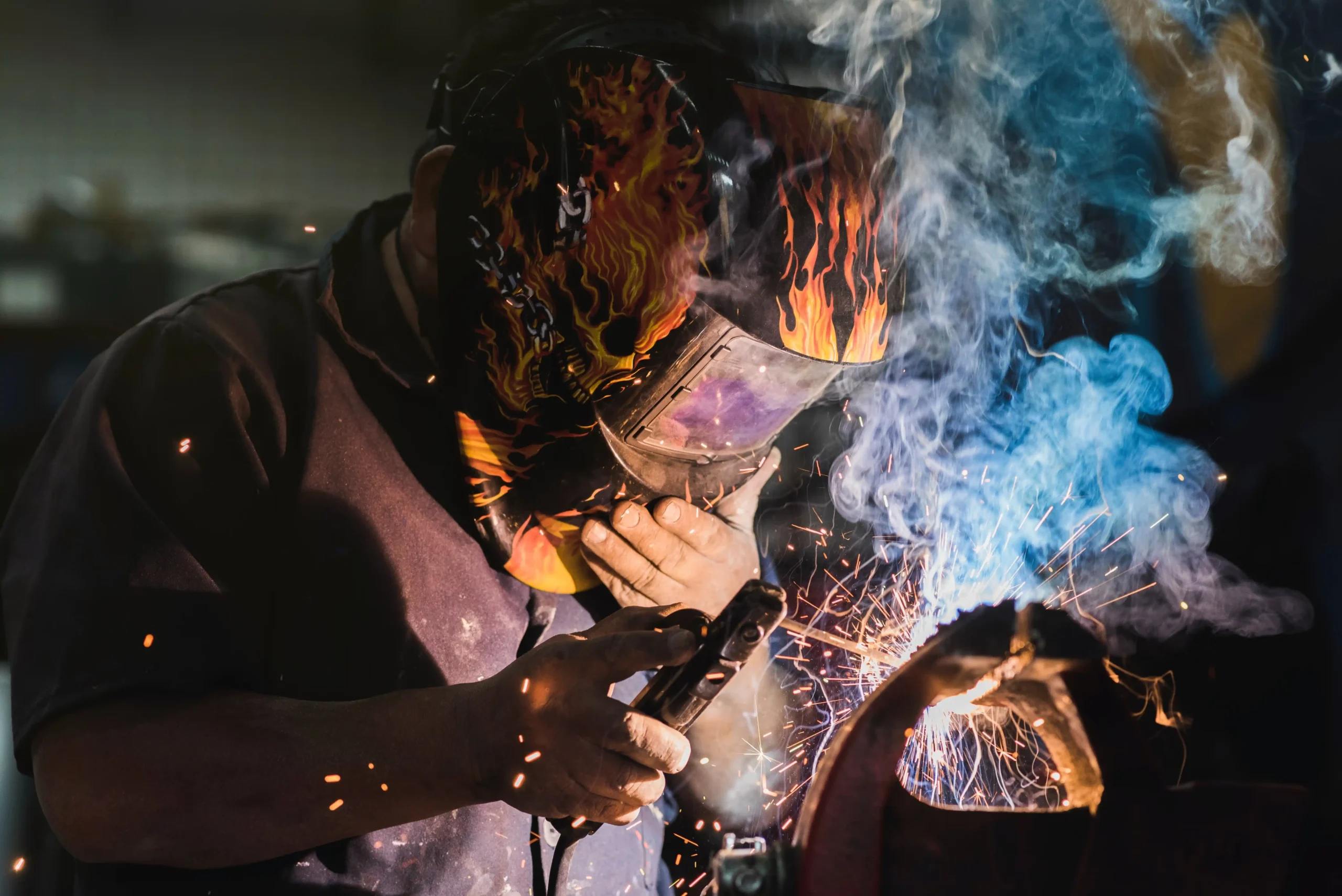 A imagem mostra um soldador trabalhando em uma fábrica. Ilustra o texto sobre se soldador tem direito à aposentadoria especial.